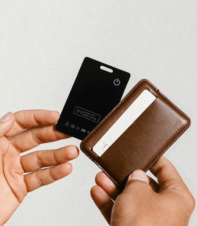 Tracking card in wallet held in hands