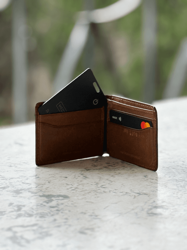 Tracking card sliding into a wallet