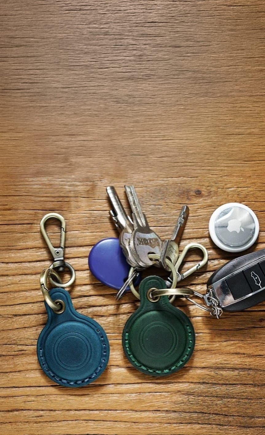 Leather Smart Tag cases on wood table